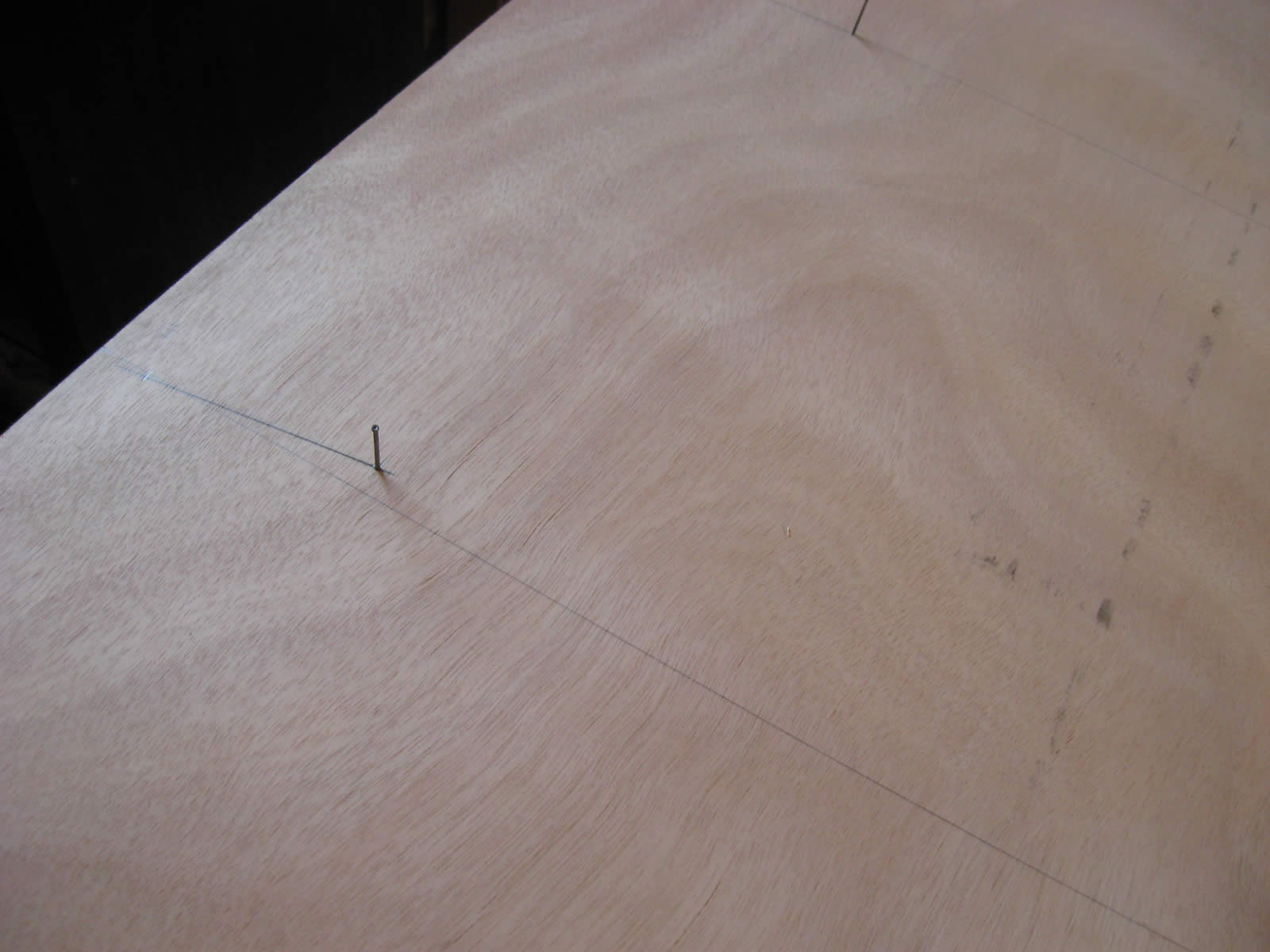 Lines laid out, nails at offset points.