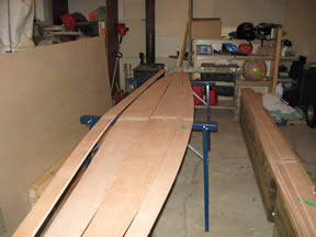 Stitching the planks into a canoe shape.