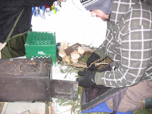 Mark lights the wood stove.