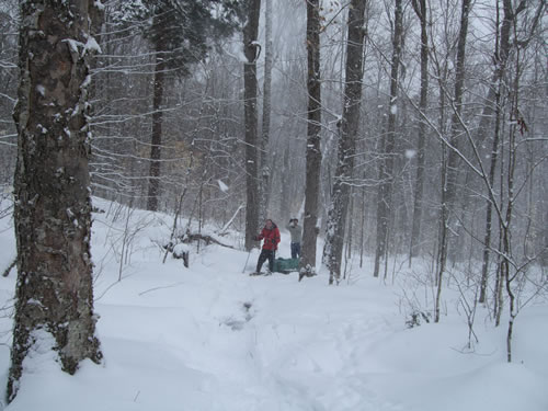 Jeffrey and Markus protect themselves from a snow gust.