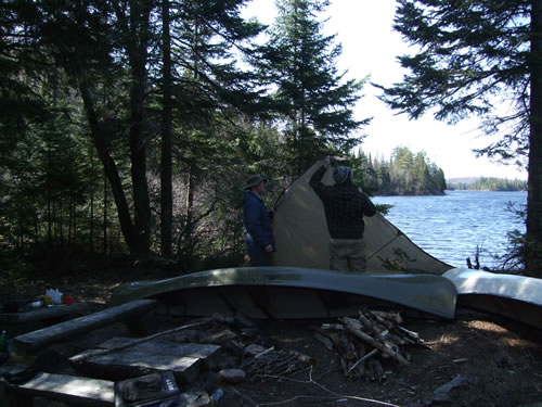 Stringing the tarp to stop the wind blowing through camp.